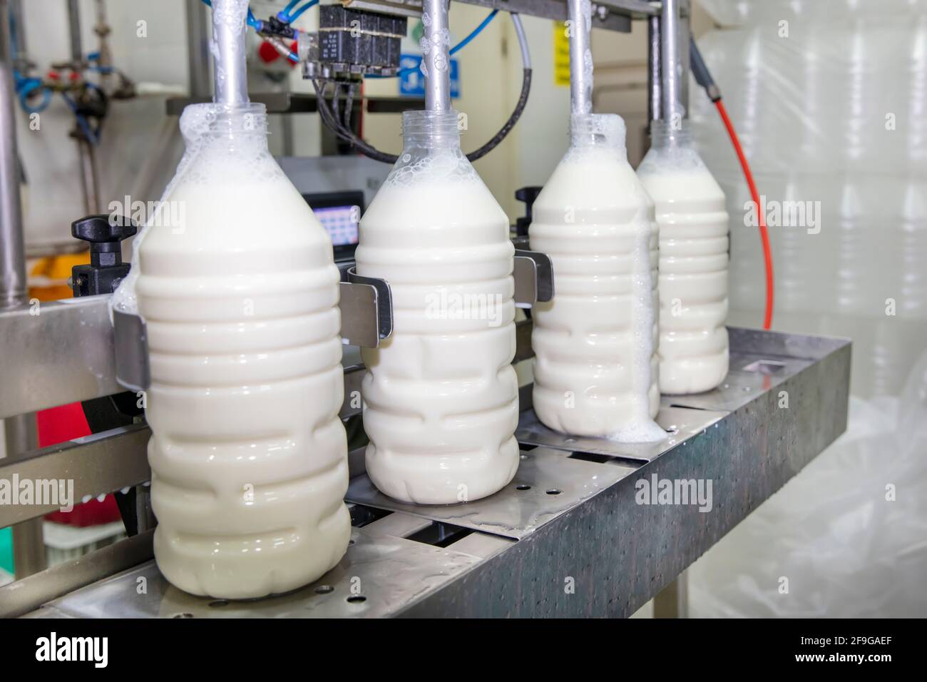 Filling Milk Into Plastic Bottles At The Factory Equipment In Dairy