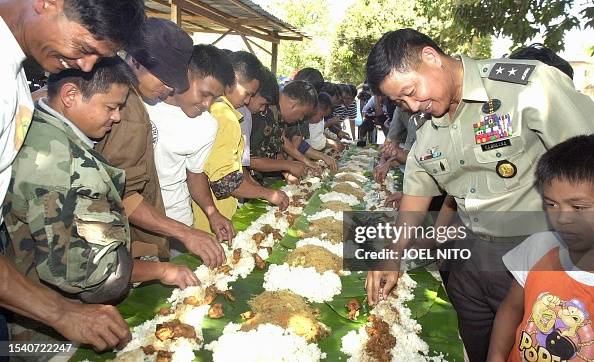 Philippine Army Major General Ernesto Carolina And A Group Of News